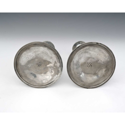 181 - Archibald Knox for Liberty and Co., a pair of Tudric Arts and Crafts pewter and enamelled candlestic... 