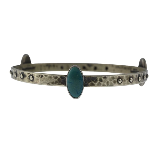 20 - Ruskin, an Arts and Crafts plated metal and cabochon set bangle, planished ring form with bead studs... 