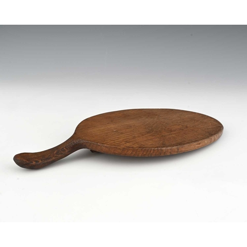 213 - Robert Mouseman Thompson (British, 1876-1955), an adzed oak cheese board, of typical form, carved mo... 