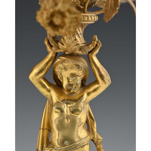 217 - A French gilt metal garniture, late 19th or early Century, modelled as classically draped cherubs up... 