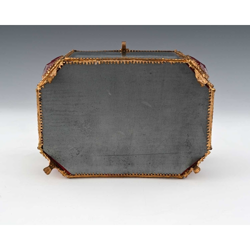 223 - A French Palais Royal gilt metal and glass panelled jewel casket, mid 19th century, canted cuboid fo... 