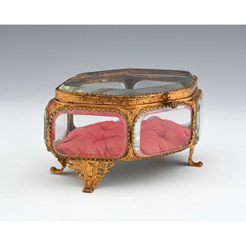 224 - A French Palais Royal gilt metal and glass panelled jewel casket, mid 19th century, navette form wit... 