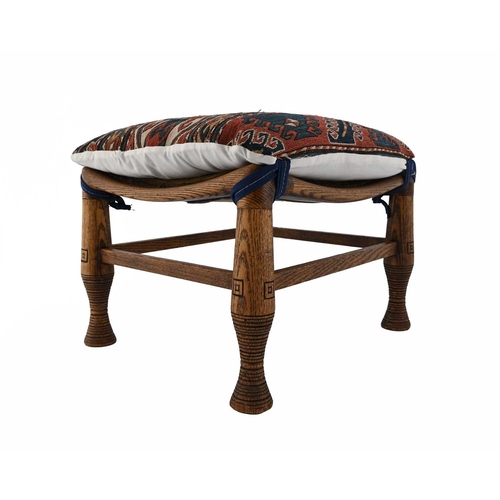 391 - Liberty and Co., an Aesthetic Movement oak Thebes stool, turned and incised legs united by stretcher... 