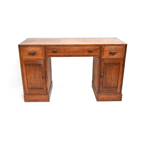 392 - A Cotswold School, Arts and Crafts oak desk, in the style of Edward Barnsley, three drawers over two... 