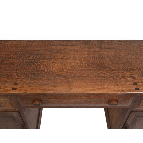 392 - A Cotswold School, Arts and Crafts oak desk, in the style of Edward Barnsley, three drawers over two... 