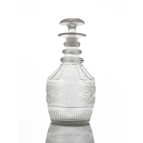 409 - An Anglo Irish glass decanter, circa 1810, of three ring neck Prussian form, the body cut with a ban... 