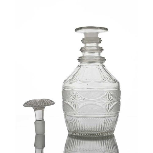 409 - An Anglo Irish glass decanter, circa 1810, of three ring neck Prussian form, the body cut with a ban... 