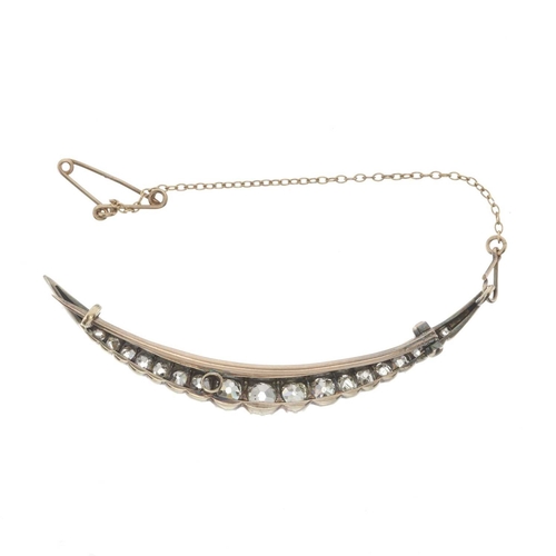 27 - A late 19th century silver and gold, old-cut diamond crescent brooch, estimated total diamond weight... 