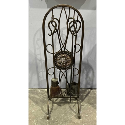 30 - A wrought metal companion set, bronzed finish, consisting of tongs, shovel, brush and poker, decorat... 