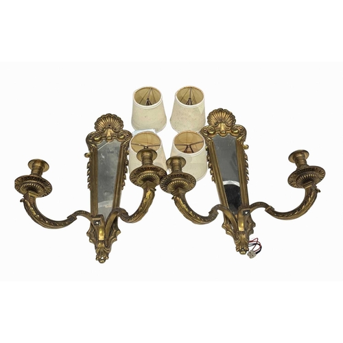 411 - A pair of 18th century style two arm brass wall lights with framed mirror back, the mirror mounted b... 