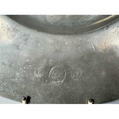 421 - A set of six heavy tin dinner plates, some with control marks, diameter 32cm, together with a larger... 