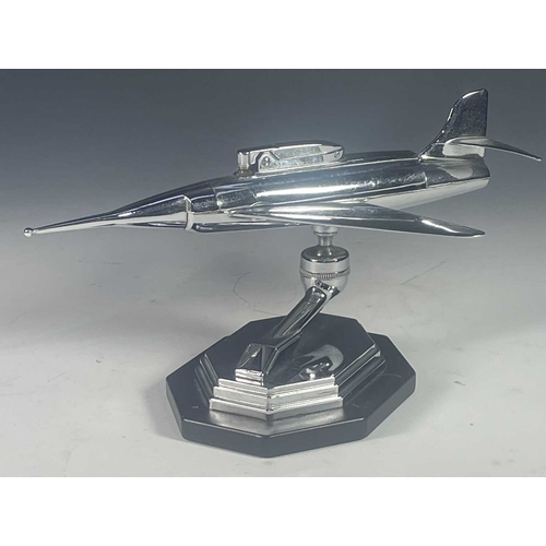 431 - A mid century chrome table lighter, formed to look like a fighter plane, raised on a ball hinge and ... 
