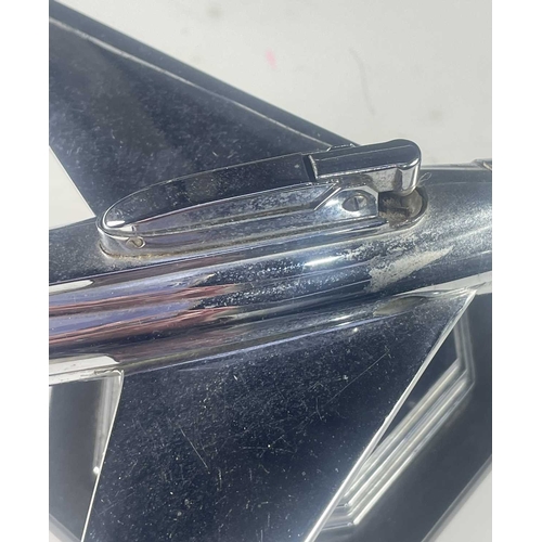 431 - A mid century chrome table lighter, formed to look like a fighter plane, raised on a ball hinge and ... 