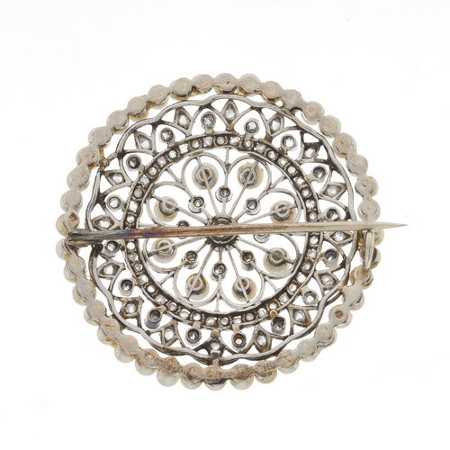 1 - An Edwardian white metal rose-cut diamond and seed pearl openwork brooch, with old-cut diamond centr... 