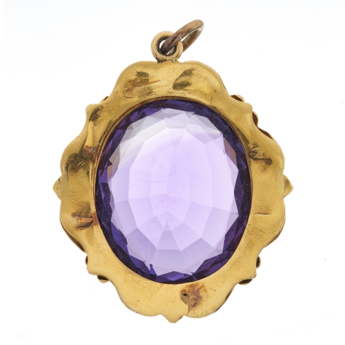14 - A late Victorian gold amethyst pendant, with scrolling surround, length 4cm, 12g