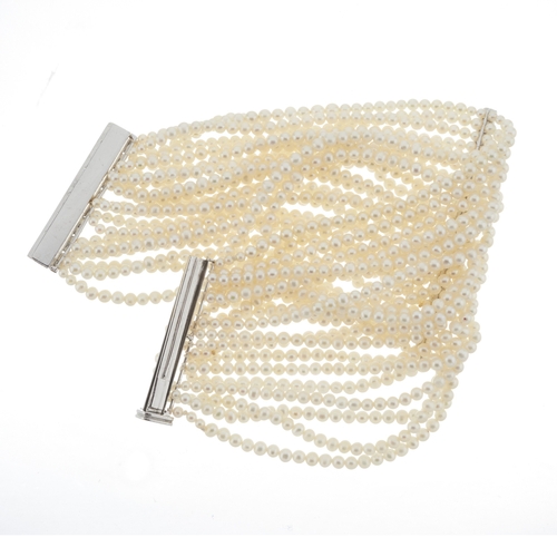 167 - An 18ct gold slightly graduated cultured pearl multi-row bracelet, with brilliant-cut diamond slidin... 