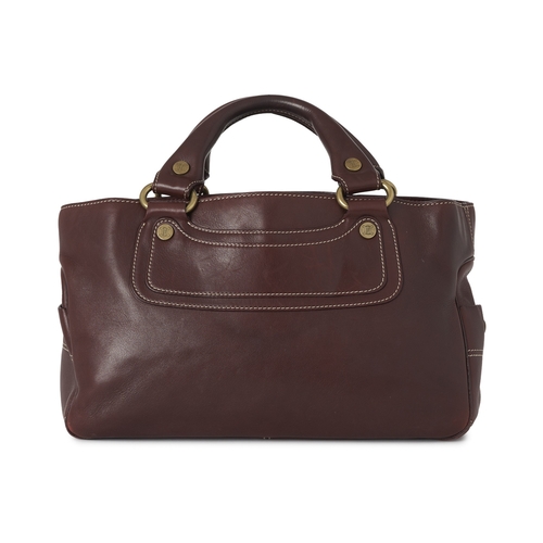 267 - Celine, a Boogie bag, crafted from burgundy leather, with brushed gold-tone logo engraved hardware, ... 