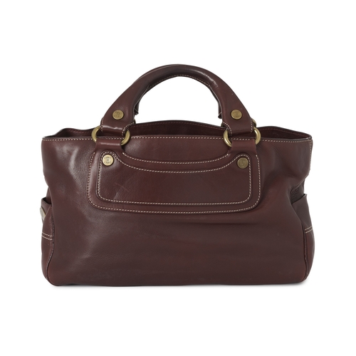 267 - Celine, a Boogie bag, crafted from burgundy leather, with brushed gold-tone logo engraved hardware, ... 