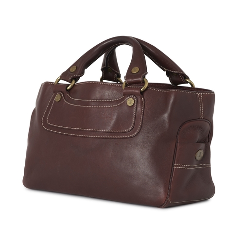 267 - Celine, a Boogie bag, crafted from burgundy leather, with brushed gold-tone logo engraved hardware, ... 