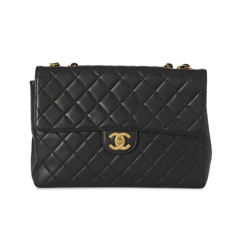 271 - Chanel, a vintage Jumbo Classic Flap handbag, crafted from black quilted lambskin leather, with 24k ... 