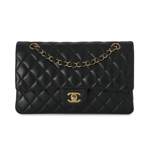 279 - Chanel, a Medium Classic Double Flap handbag, designed with a quilted black caviar leather exterior,... 