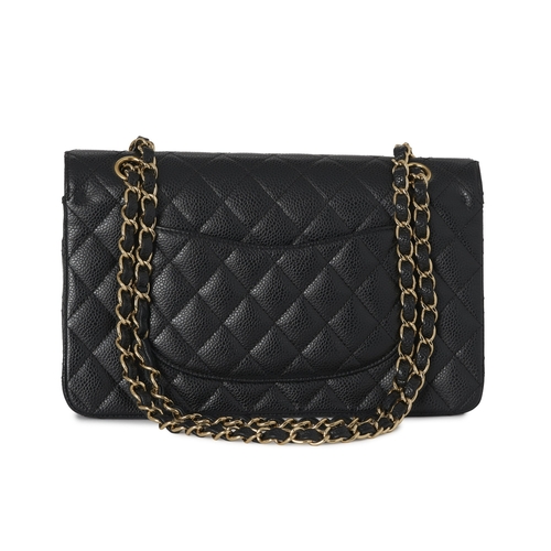 283 - Chanel, a Medium Classic Double Flap handbag, designed with a quilted black caviar leather exterior,... 