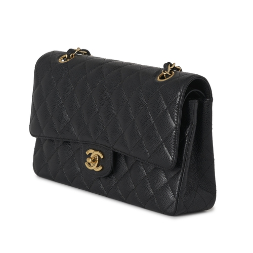 283 - Chanel, a Medium Classic Double Flap handbag, designed with a quilted black caviar leather exterior,... 