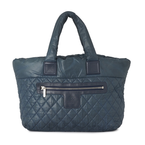 291 - Chanel, a large Coco Cocoon tote bag, designed with a diamond quilted, teal, nylon exterior, with bl... 