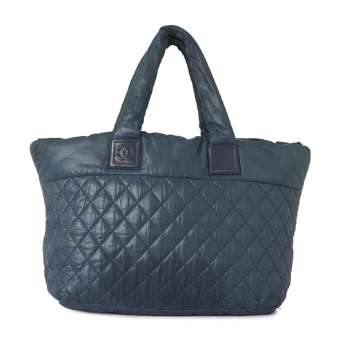 291 - Chanel, a large Coco Cocoon tote bag, designed with a diamond quilted, teal, nylon exterior, with bl... 