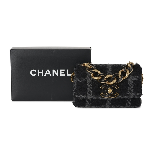 296 - Chanel, a Tweed 19 Flap handbag, featuring a black and grey tweed exterior, with gold-tone hardware,... 