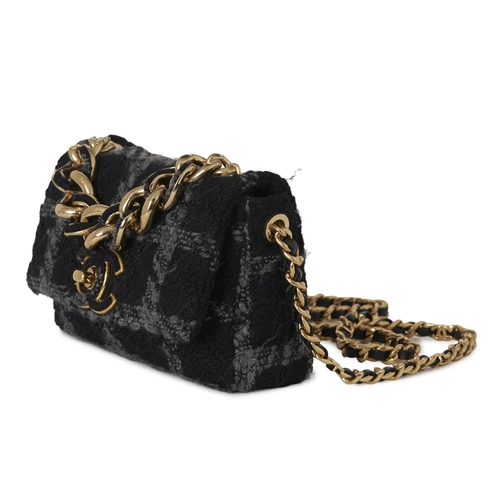 296 - Chanel, a Tweed 19 Flap handbag, featuring a black and grey tweed exterior, with gold-tone hardware,... 