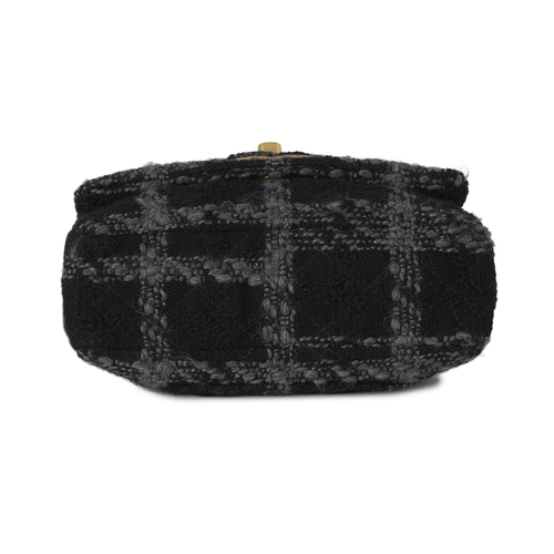 296 - Chanel, a Tweed 19 Flap handbag, featuring a black and grey tweed exterior, with gold-tone hardware,... 