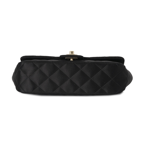 297 - Chanel, a satin Mini Flap handbag, crafted from quilted black satin, with gold-tone hardware, a long... 