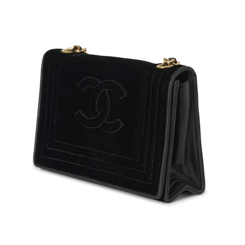 298 - Chanel, a vintage black velvet Classic Flap handbag, designed with black leather trim, featuring emb... 