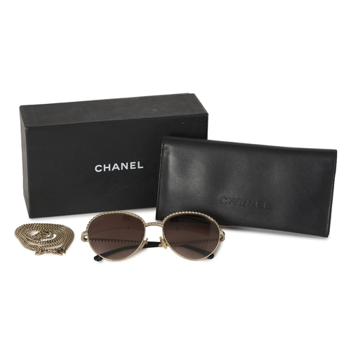 306 - Chanel, a pair of Pantos sunglasses with chain, featuring gold-tone metal frames, brown gradient len... 
