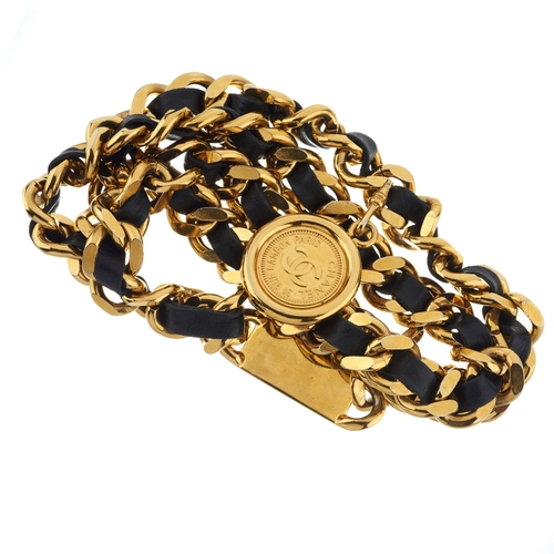 308 - Chanel, a chain belt, interwoven black leather between the gold-tone chain belt, with Chanel panel, ... 
