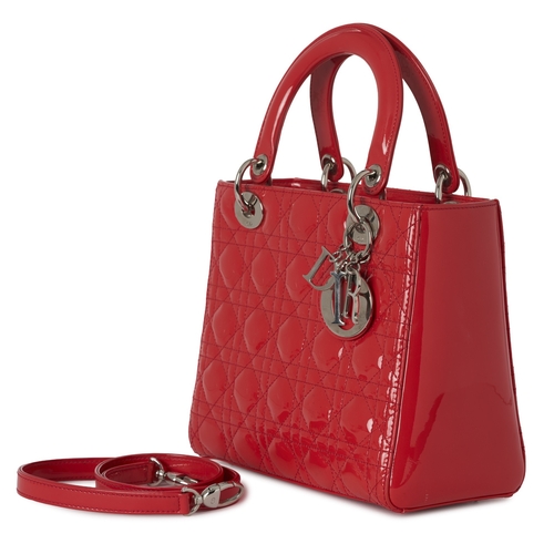 319 - Christian Dior, a red patent leather Lady Dior MM handbag, designed with Dior's signature cannage qu... 