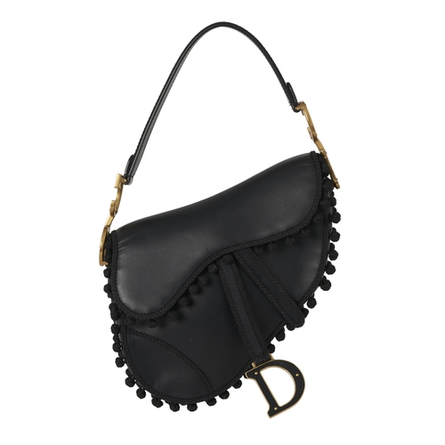 322 - Christian Dior, a calfskin Pom Pom Saddle bag, crafted from black calfskin leather, featuring braide... 