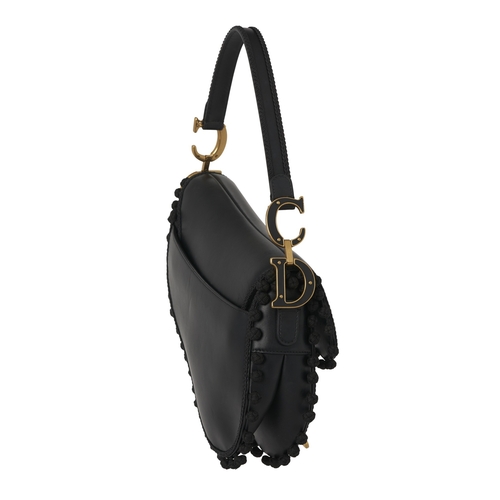 322 - Christian Dior, a calfskin Pom Pom Saddle bag, crafted from black calfskin leather, featuring braide... 