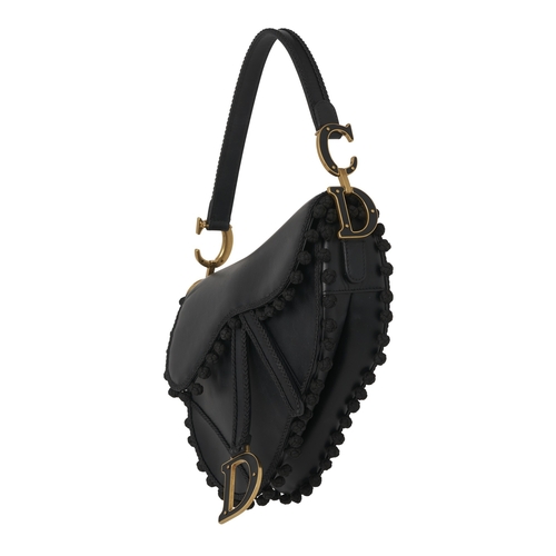 322 - Christian Dior, a calfskin Pom Pom Saddle bag, crafted from black calfskin leather, featuring braide... 
