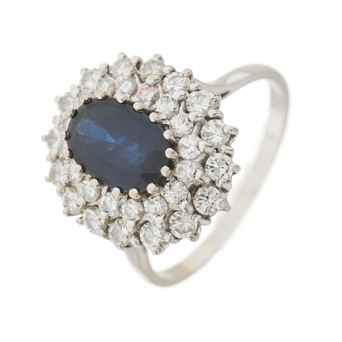 35 - An 18ct gold sapphire and brilliant-cut diamond cluster dress ring, sapphire estimated weight 2.20ct... 