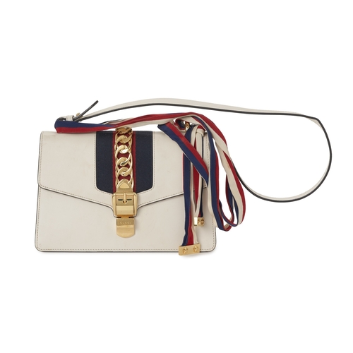 368 - Gucci, a Sylvie Web handbag, designed with a smooth white leather exterior, featuring a blue and red... 
