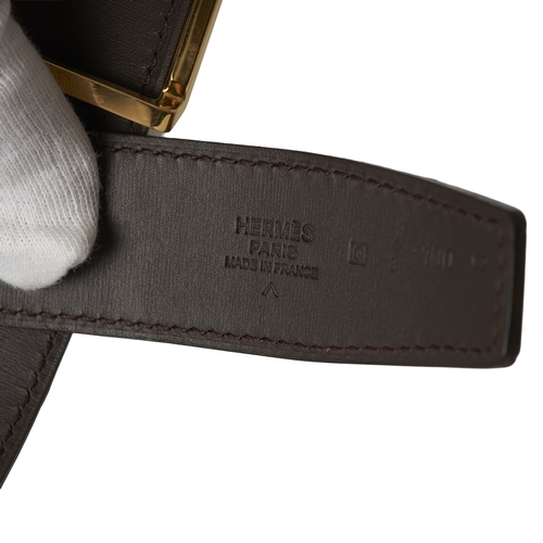 395 - Hermes, a 2013 glossy brown Porosus Crocodile H belt, featuring a thin gold-tone H belt with pin fas... 