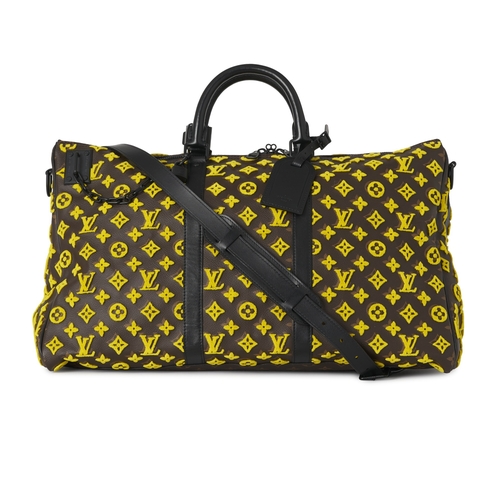 422 - Louis Vuitton, a monogram Tuffetage Triangle Keepall Bandouliere 50 luggage bag, designed with a bro... 