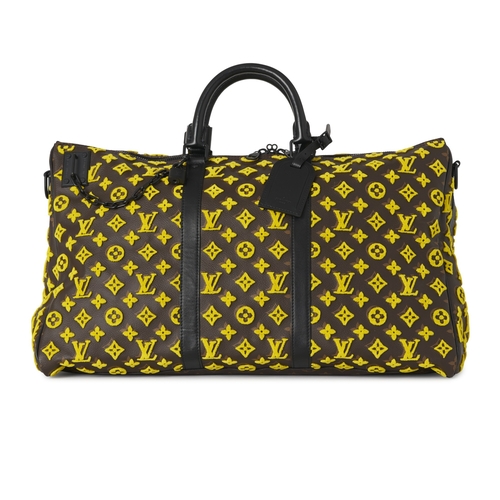422 - Louis Vuitton, a monogram Tuffetage Triangle Keepall Bandouliere 50 luggage bag, designed with a bro... 