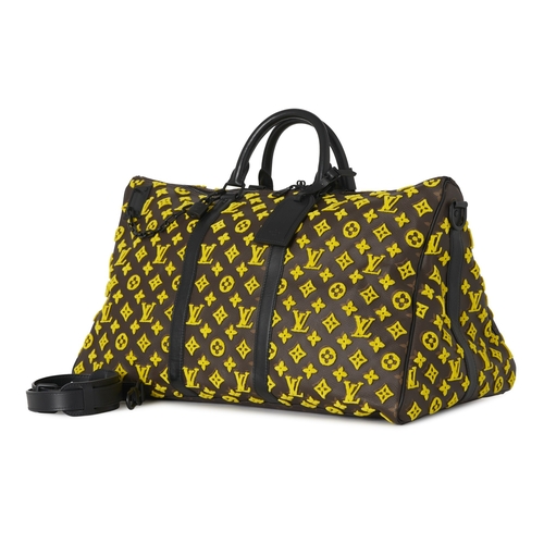 422 - Louis Vuitton, a monogram Tuffetage Triangle Keepall Bandouliere 50 luggage bag, designed with a bro... 