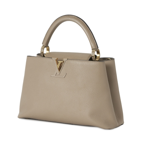 443 - Louis Vuitton, a Capucines PM handbag, crafted from grey Taurillion leather with gold-tone hardware,... 