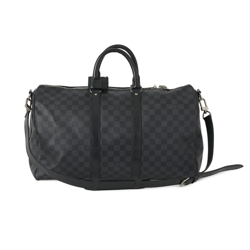 453 - Louis Vuitton, a damier graphite Keepall 45 luggage bag, featuring black leather trim, rolled leathe... 