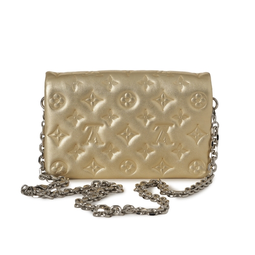 455 - Louis Vuitton, a gold Pochette Coussins pouch, featuring a monogram embossed puffy lambskin leather ... 