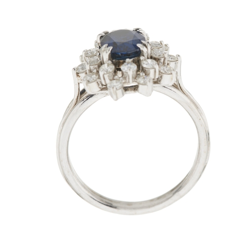 46 - A sapphire and brilliant-cut diamond cluster dress ring, with grooved band, sapphire estimated weigh... 